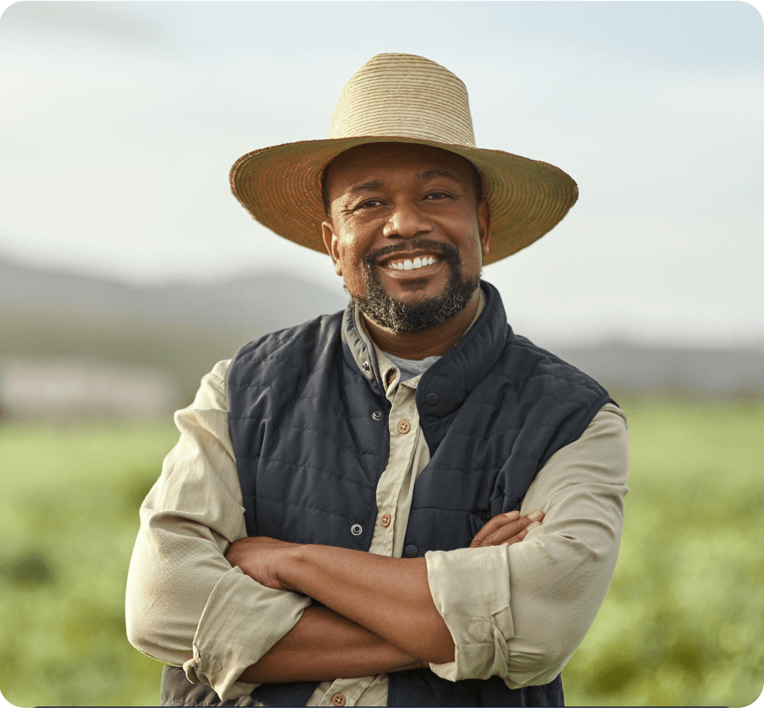A farmer standing in a cultivated field